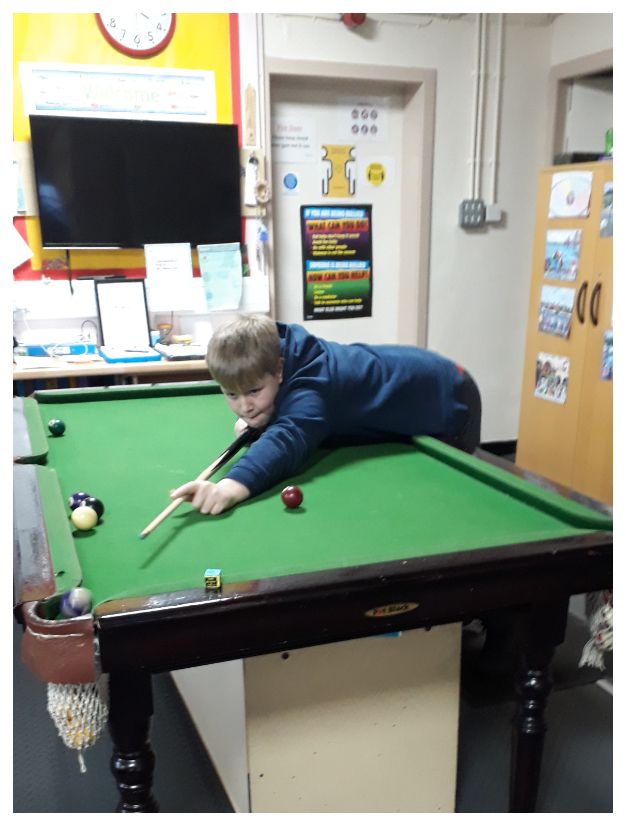 young child playing snooker